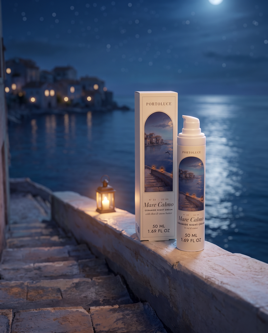 Mare Calmo Ceramide Night Cream and box on a stone wall by a lantern at night above the sea