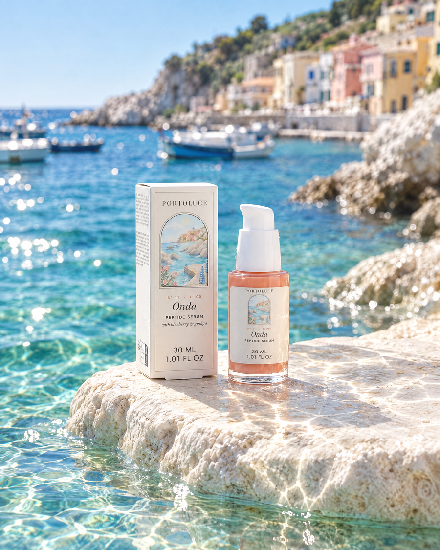 Onda Peptide Serum and its box on a wet limestone step above a turquoise cove